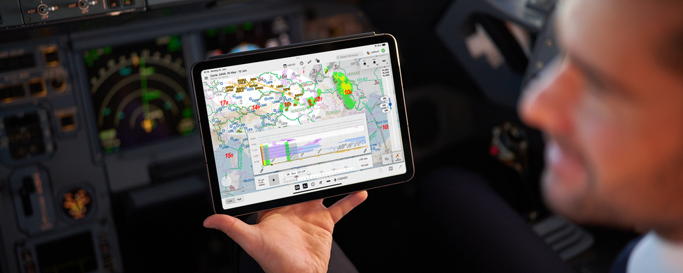 Pilot holding screen in cockpit with Lido mPilot