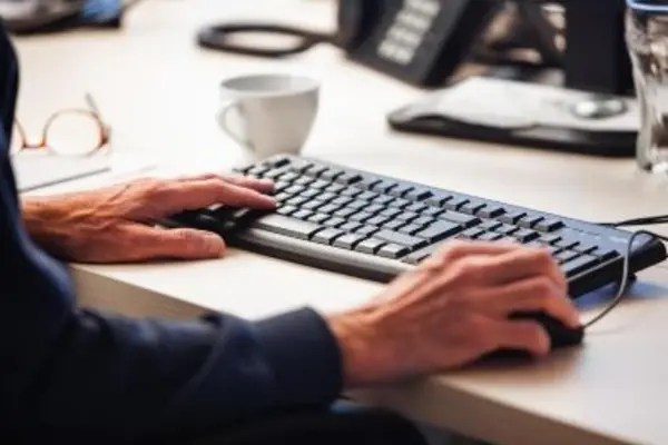 Man using computer keyboard on desk