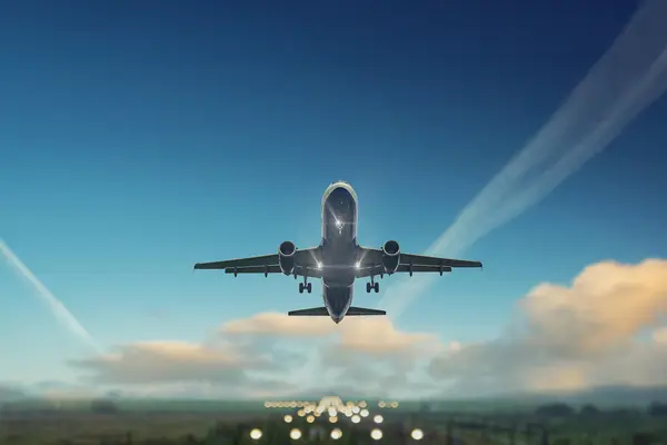 Commercial aircraft taking off above the runway under a clear blue sky