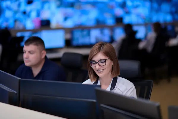 Workstations in an operations control center with multiple screens for monitoring flight operations