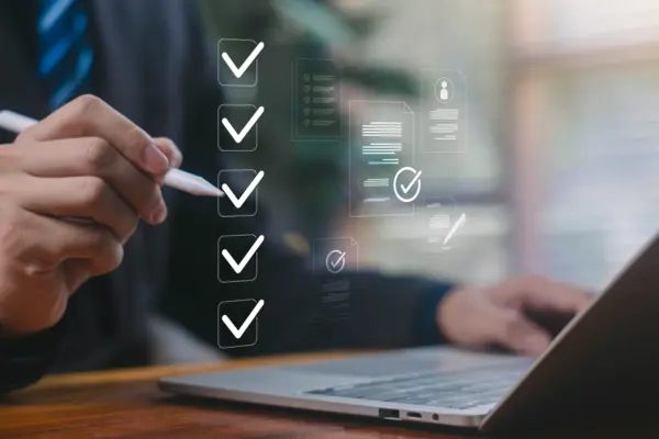 Businessman marking digital checkboxes on a laptop, showing task management, checklist review, verification process, modern digital workspace. check of document, list survey, form business