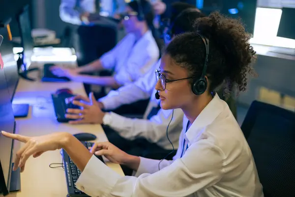 Team uses headsets and screens to monitor and manage operational processes