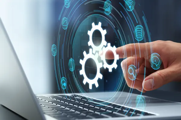Digital interface with gear icons representing system integration on a laptop