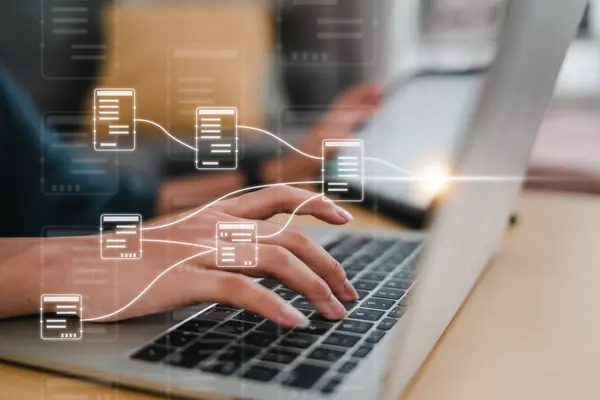 Working on a laptop with connected document icons