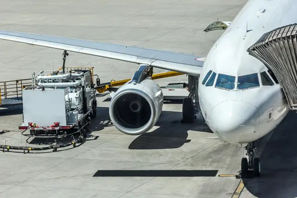 airplane on ground getting fuel