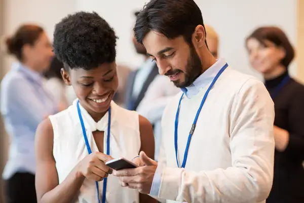 People in a room talking to each other and sharing information on smartphone