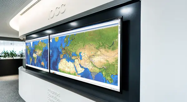 Large world map displays in an airline operations center for flight monitoring