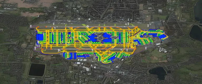 Overview map of a large airport with color‑coded taxiways, buildings, and operational areas