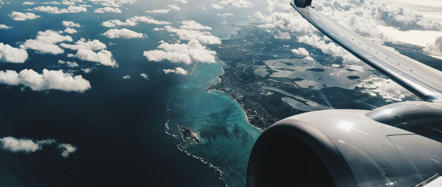 View from an airplane with aircraft engine and wings  in the field of vision