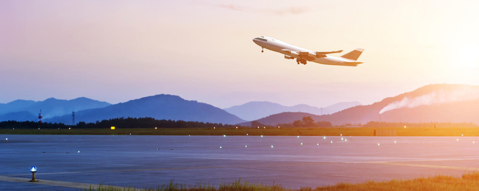  Passenger plane over take-off runway at sunset (© Shutterstock/hxdyl) 