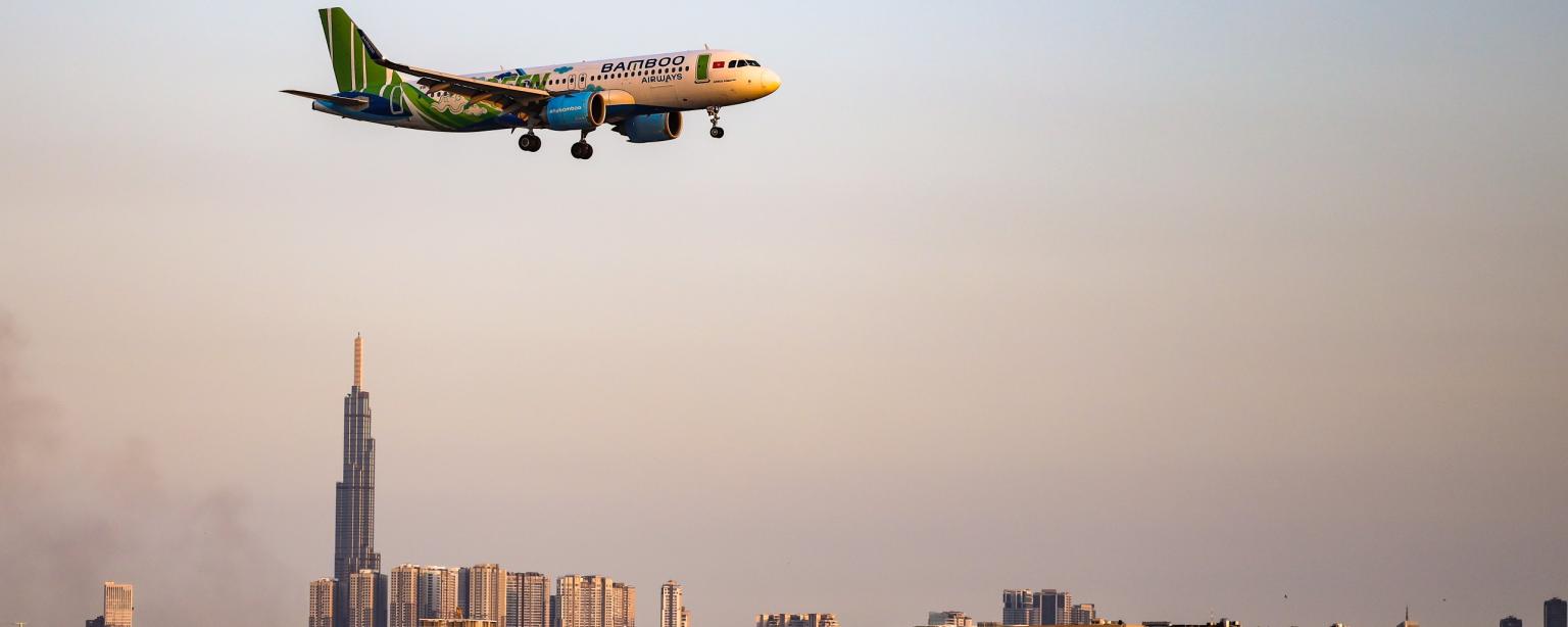 Bamboo Airways aircraft flying over a city