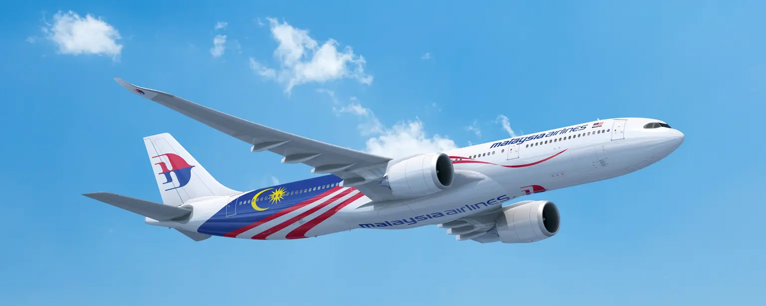 Malaysia Airlines aircraft in the air with a slightly cloudy sky, model A330 neo