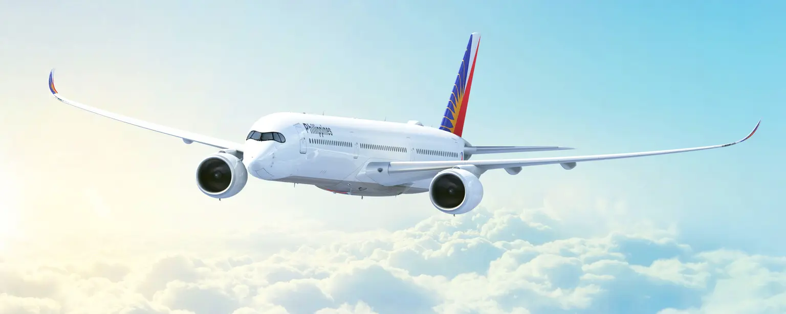 Philippine Airlines plane flying above clouds