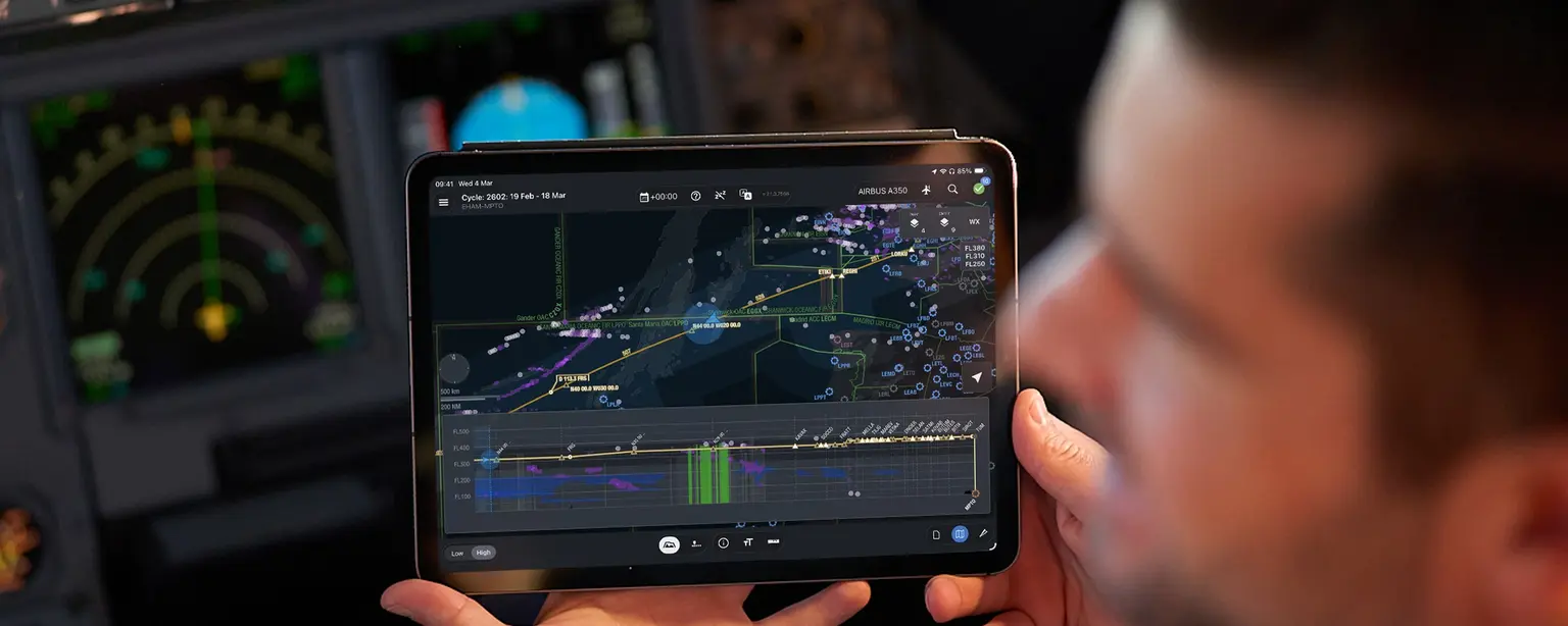 Pilot holding iPad with Lido mPilot in cockpit